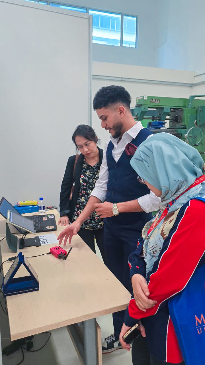 Adam showing the Raspberry Pi travel router to visitors at an exhibition booth